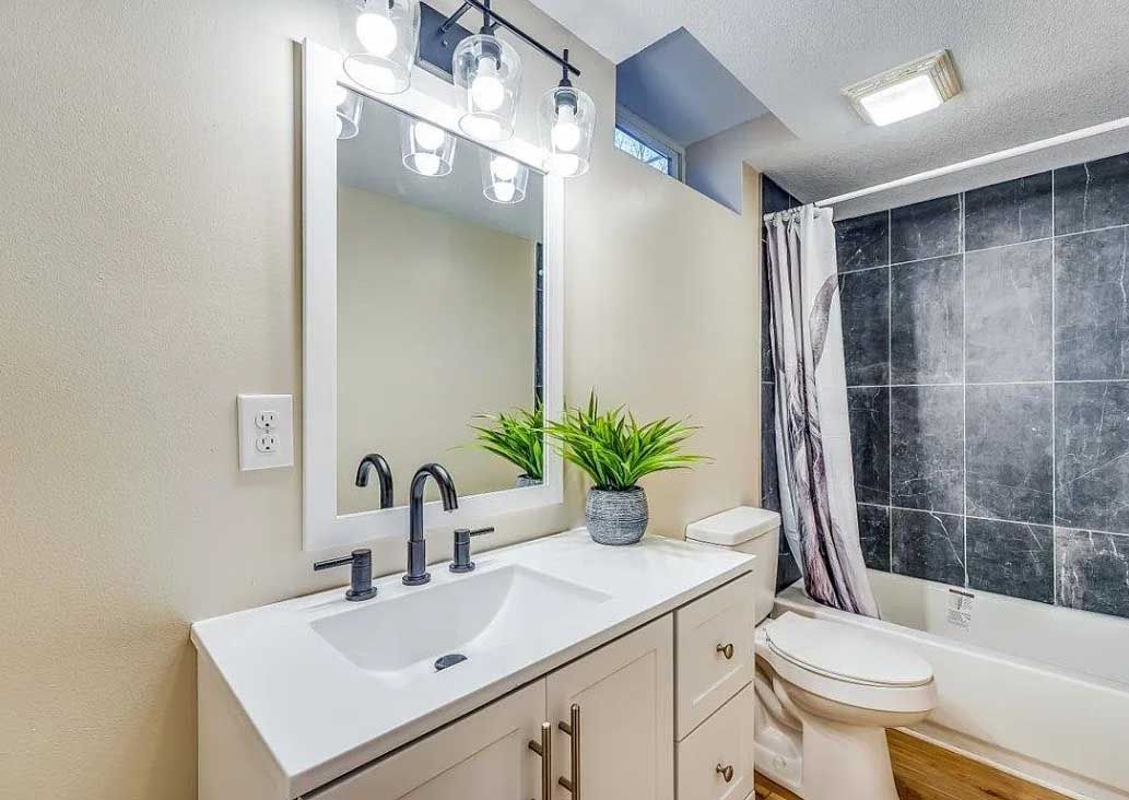 A bathroom with a sink , toilet , and bathtub.