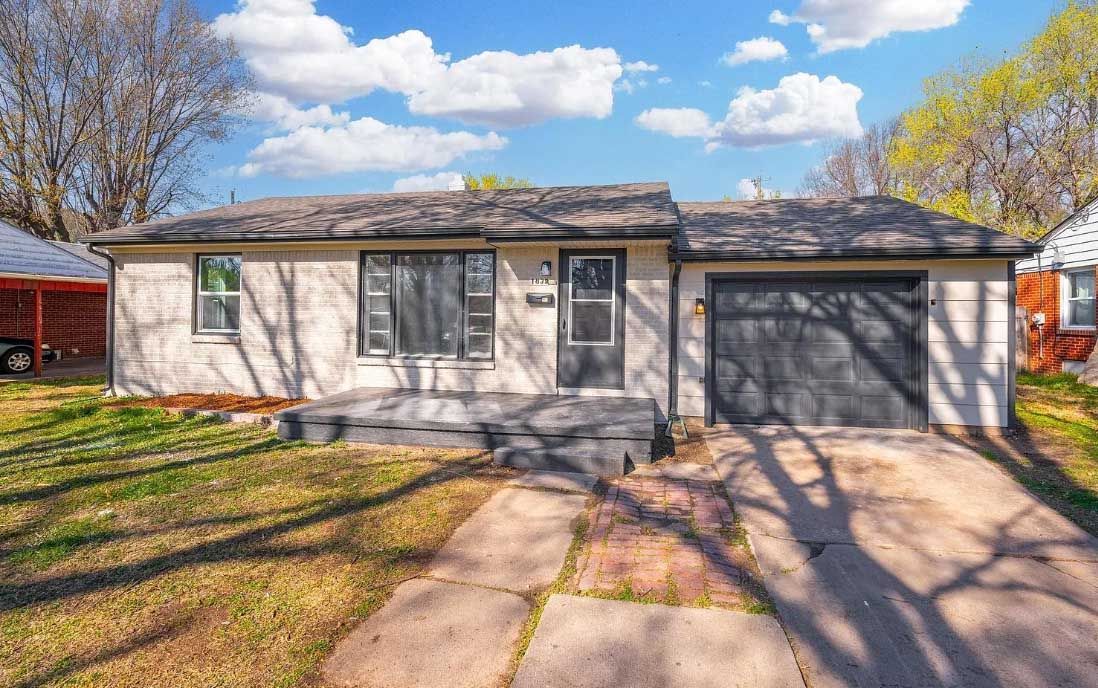 The front of a house with a garage and a driveway.