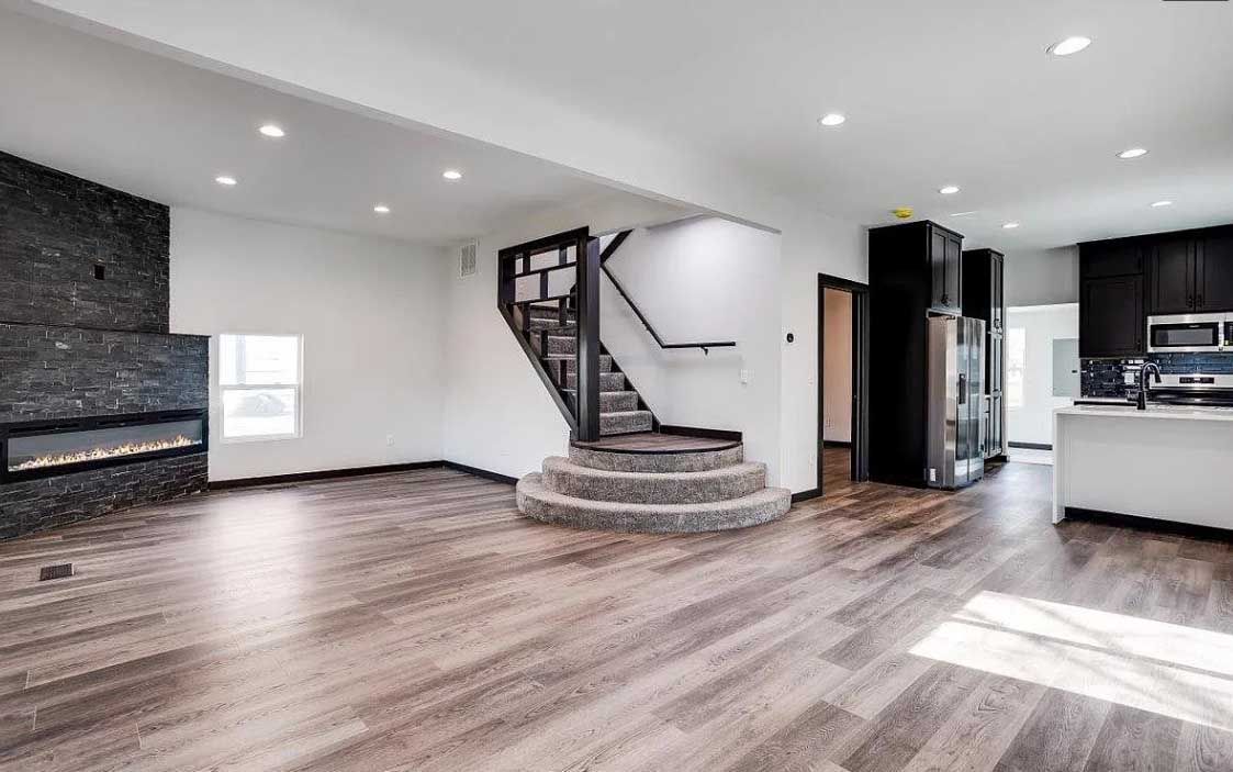 There is a staircase in the middle of the living room.