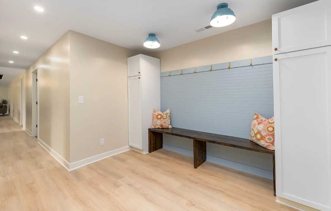 There is a bench in the middle of the hallway.