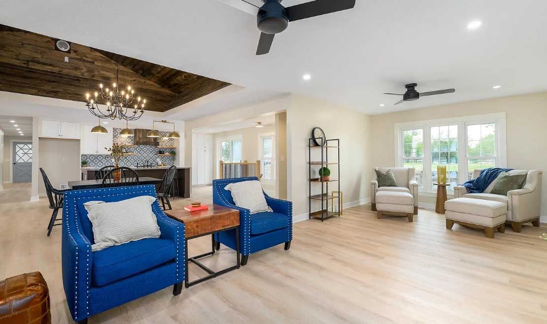 A living room filled with furniture and a ceiling fan.