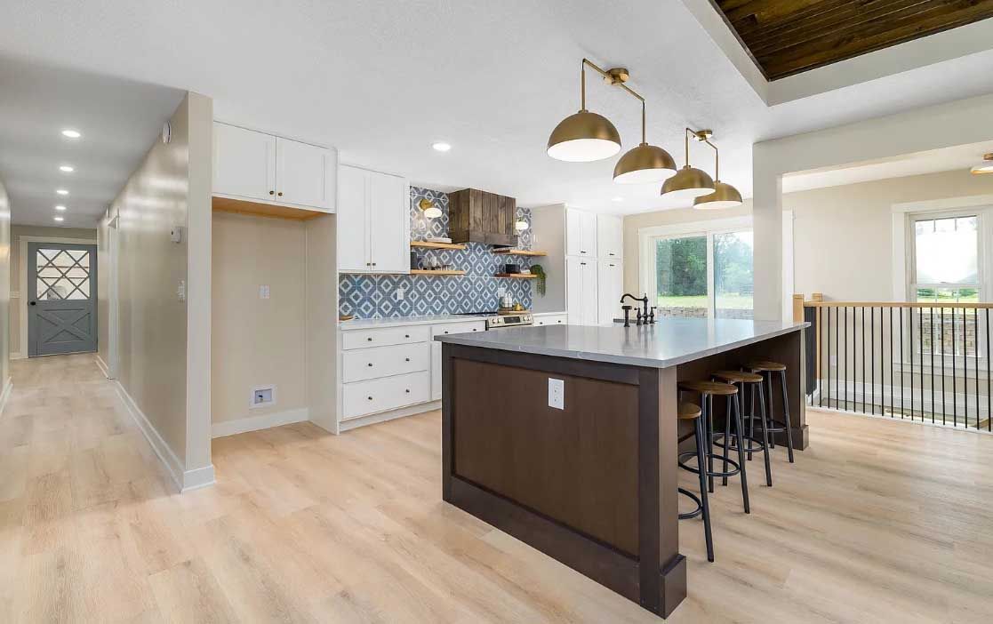 There is a large island in the middle of the kitchen.