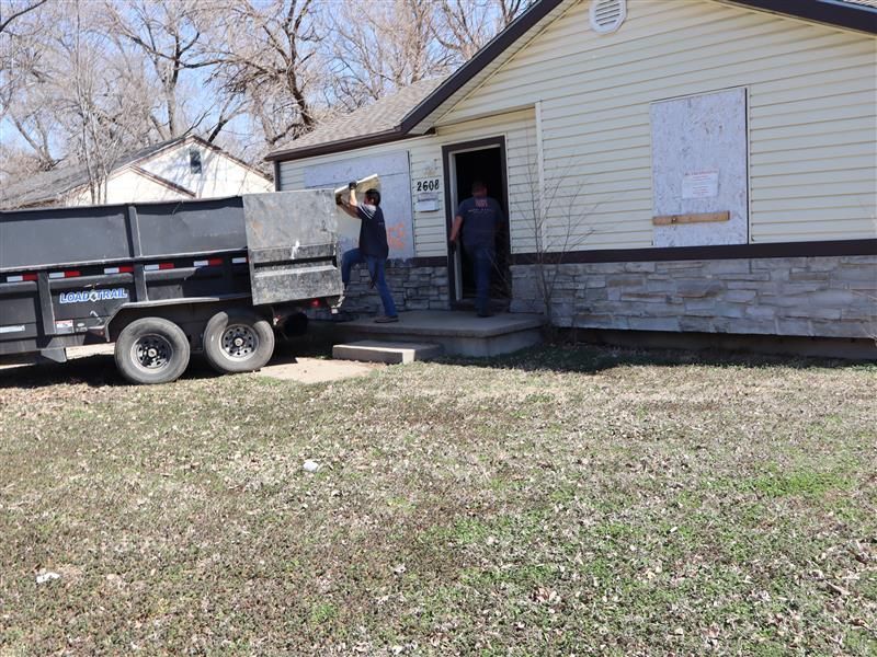 Demolition debris removal crew clearing a large construction site