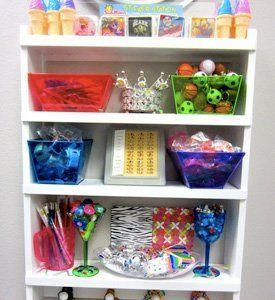 A shelf filled with lots of toys and candy.