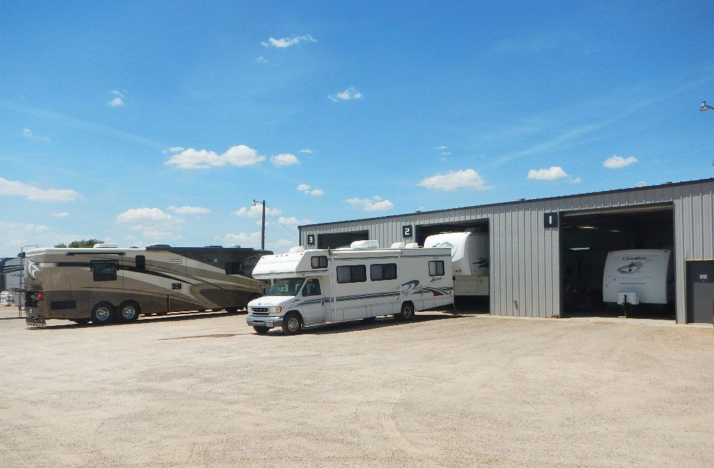 A row of rvs parked in front of a building.