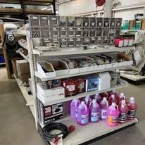 A store shelf filled with lots of bottles and boxes.