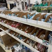 A store shelf filled with lots of boxes of various items.