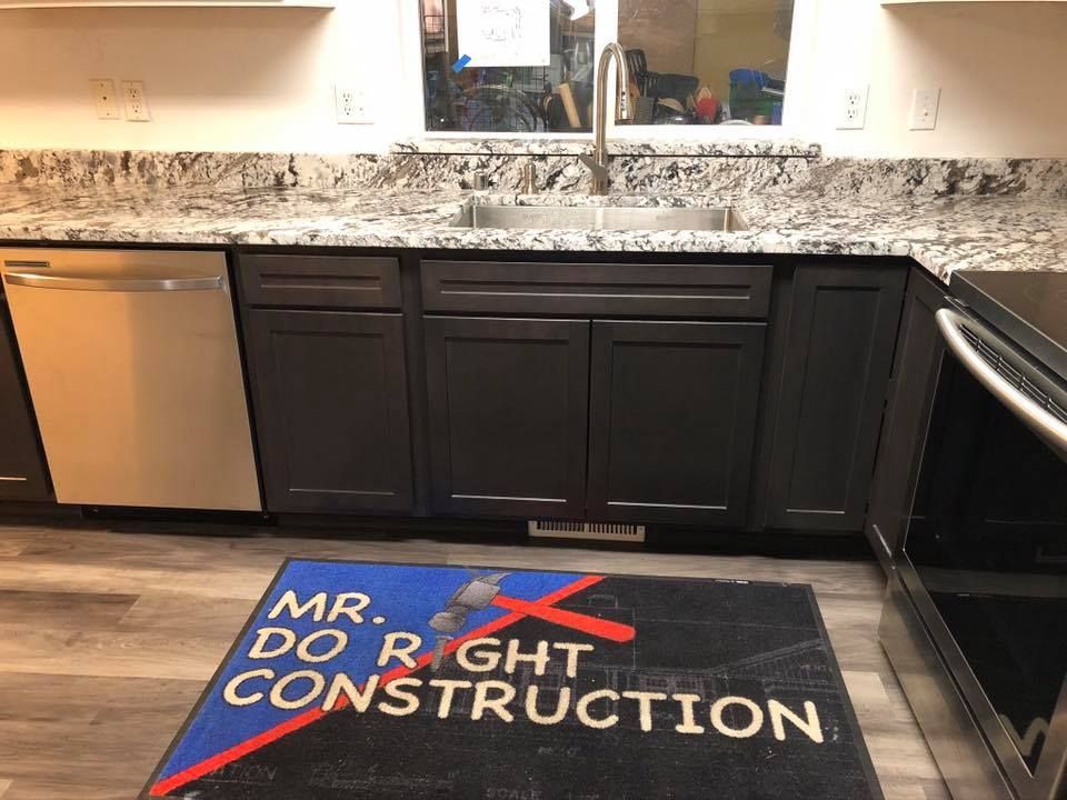 Kitchen with dark cabinets, stainless steel appliances, granite countertops, and a 