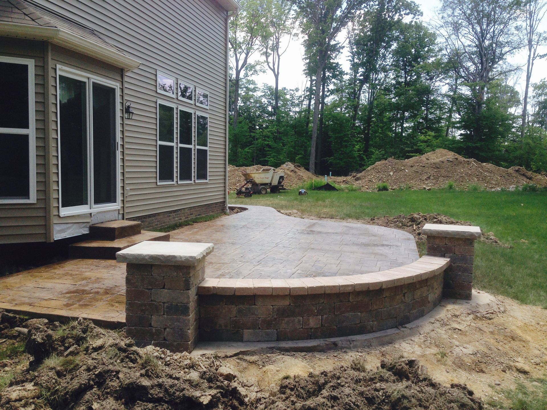 A patio is being built in front of a house