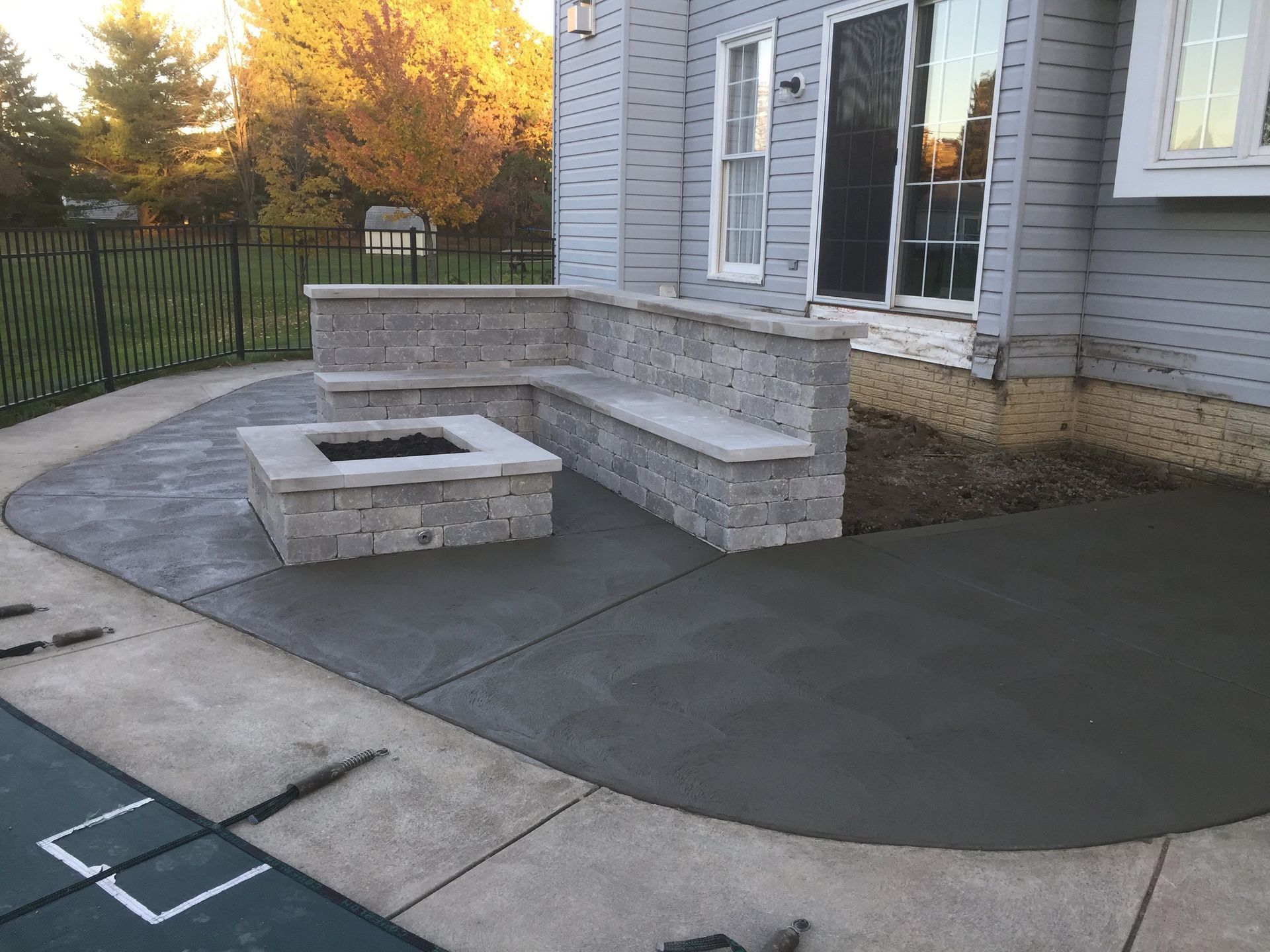 There is a fire pit in the middle of the patio.