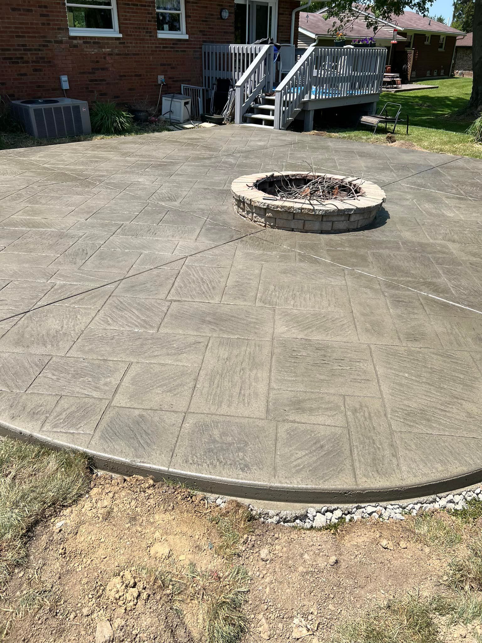 There is a fire pit in the middle of the patio.