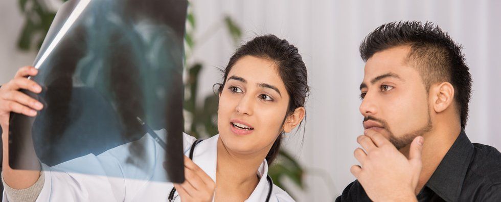Doctor showing an xray to her patient