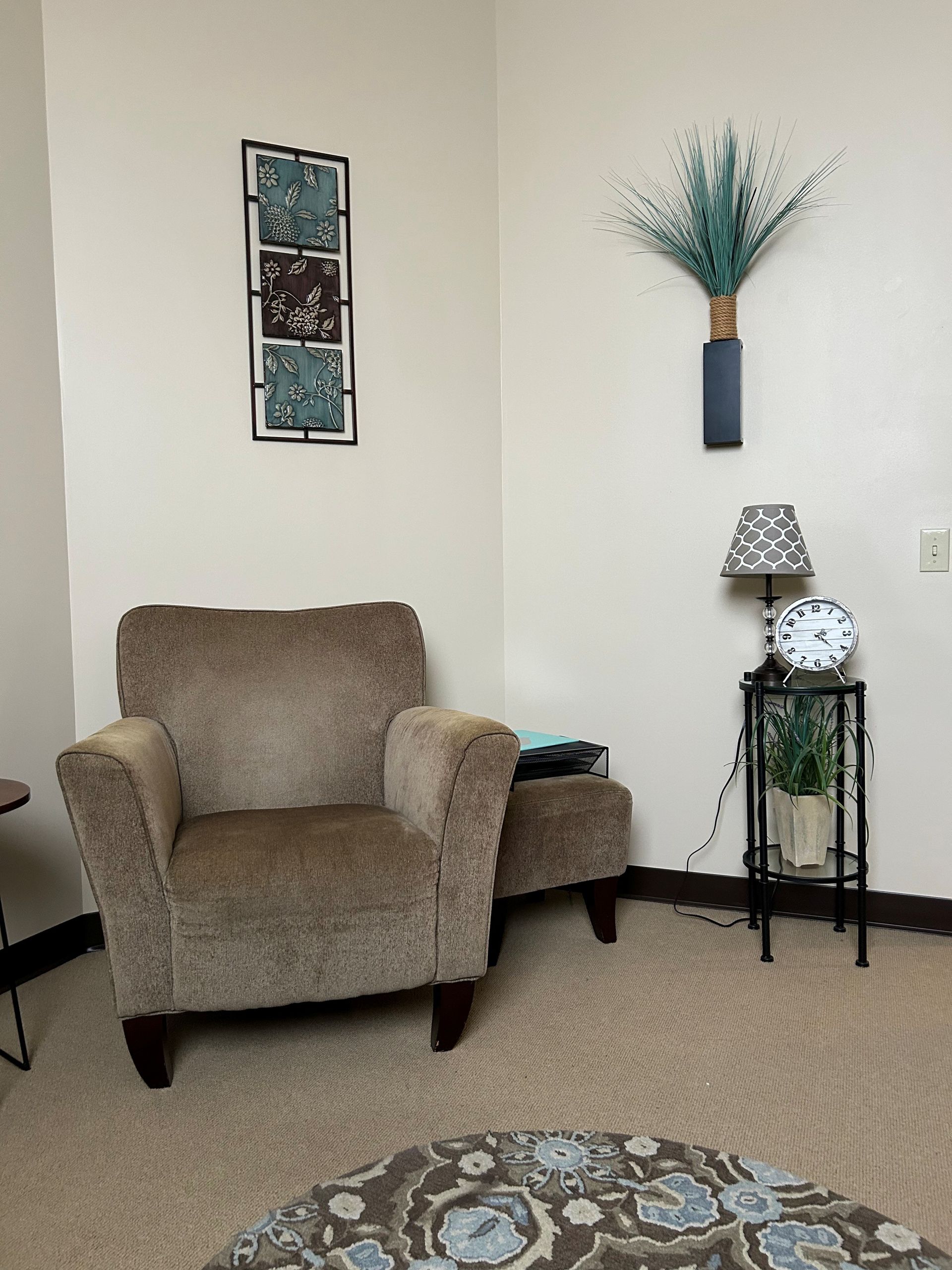 A living room with a chair and a lamp.