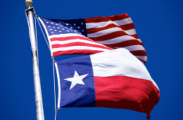 The flags of America and Texas on pole