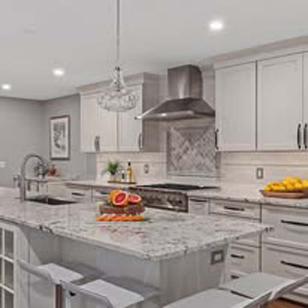 Kitchen with white cabinets, island with fruit, and stainless steel range hood.