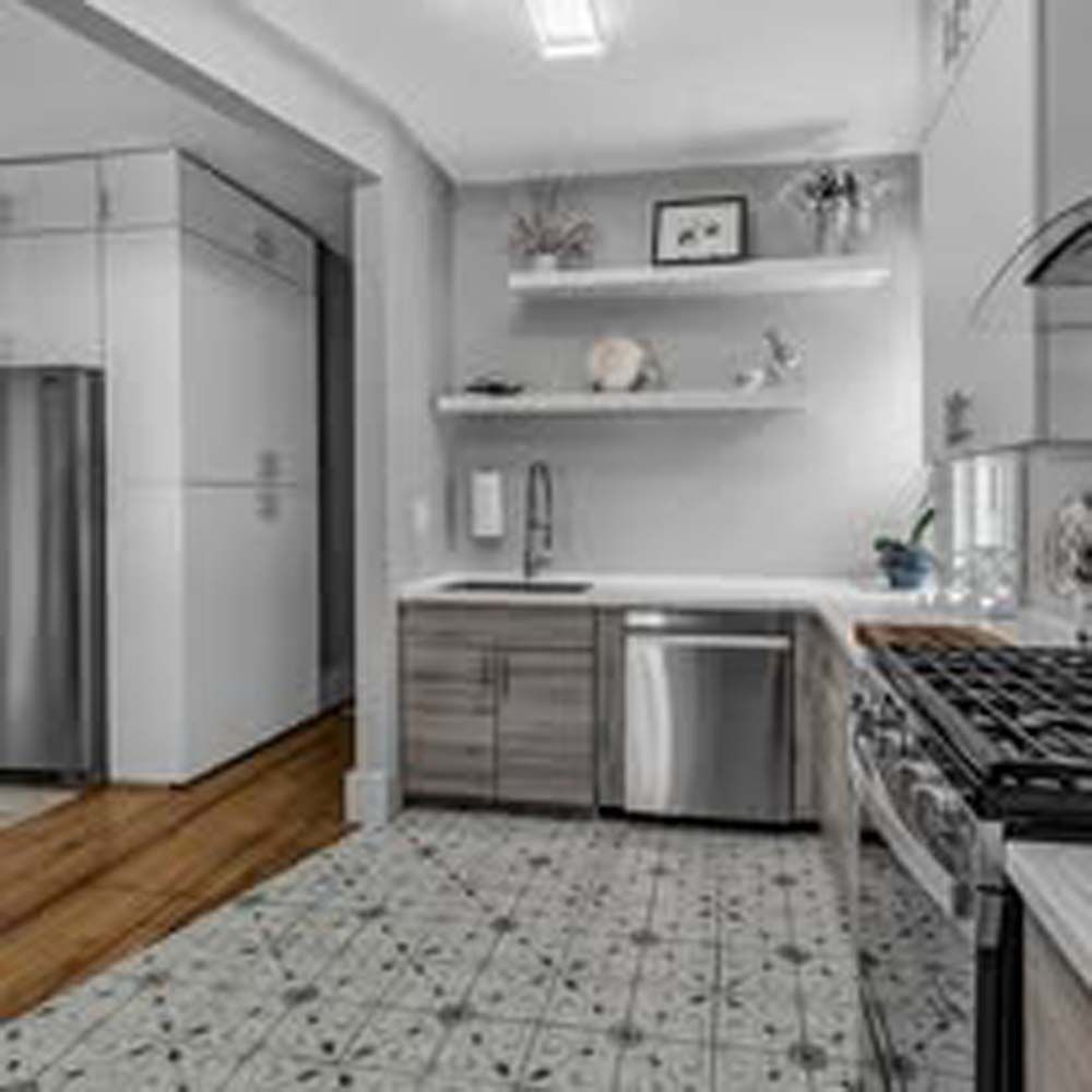 A bright modern kitchen with white shelves, stainless steel appliances, and a patterned tile floor.
