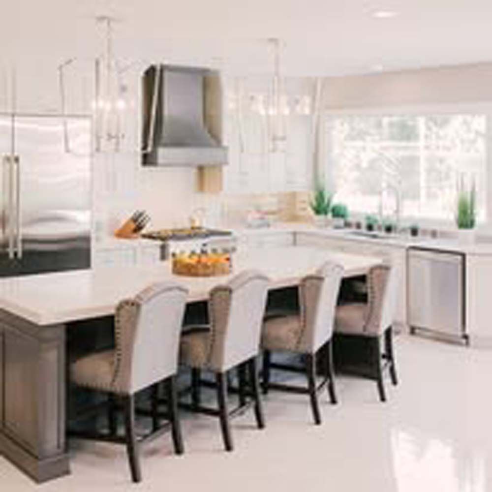 Modern kitchen with white countertops, stainless steel appliances, and seating at island.