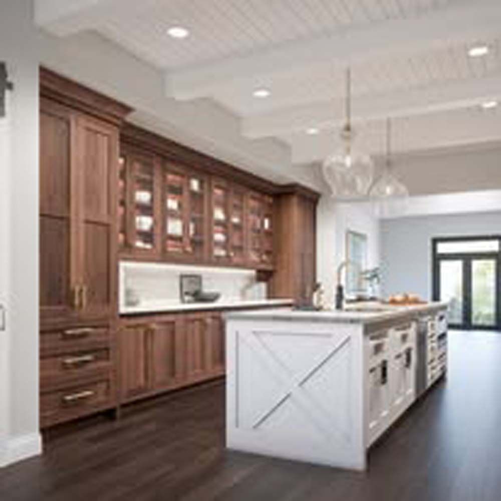 Kitchen with dark wood cabinets, white island, and dark wood floor.