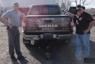 Bugman black truck with two guys