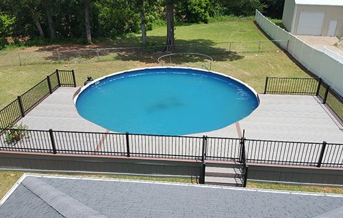 An aerial view of a swimming pool with a fence around it