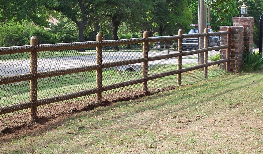 A wooden fence with a chain link fence behind it