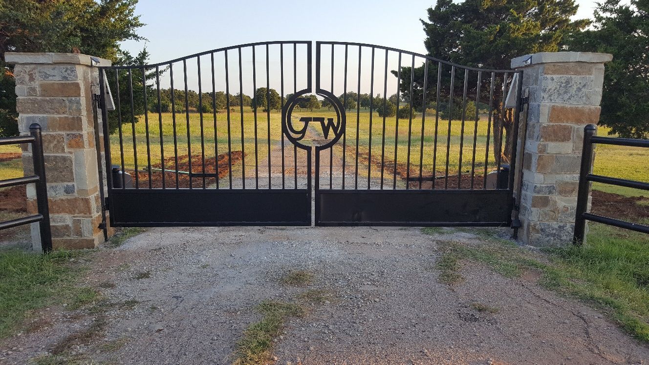 A wrought iron gate with the letters gw on it