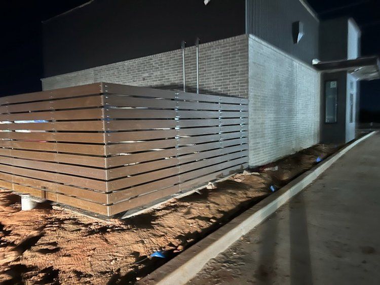 A house with a wooden fence in front of it