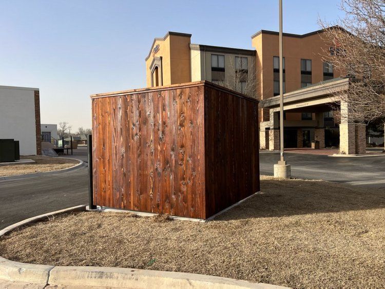 A wooden fence is sitting in front of a building