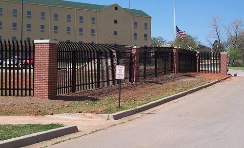 A fence with a no parking sign in front of it