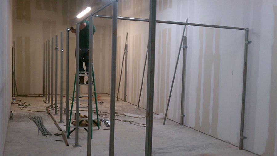 A man is standing on a ladder in a room.
