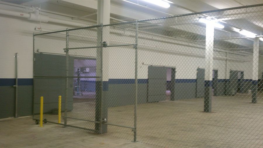An empty warehouse with a chain link fence around it