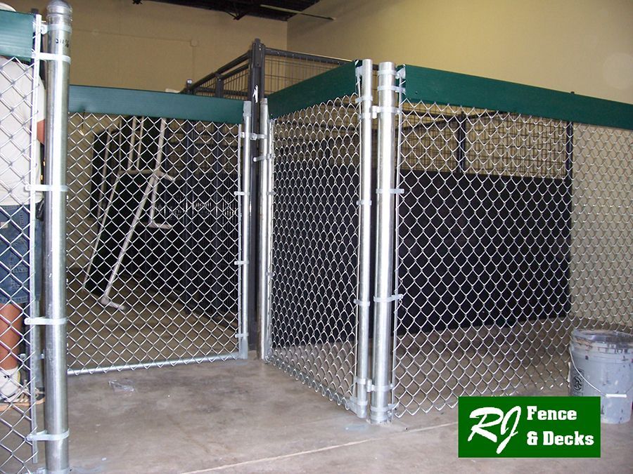 A chain link fence with a sign that says rj fence & decks