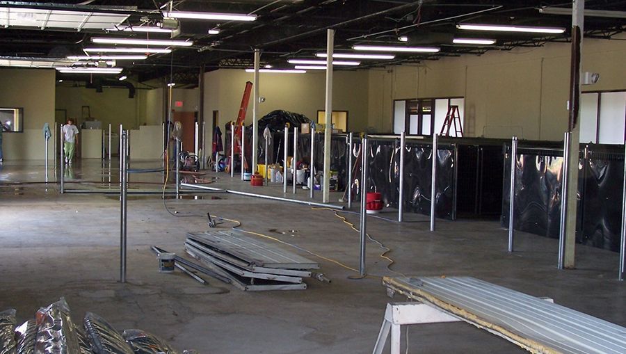 A large empty warehouse with a lot of lights on the ceiling