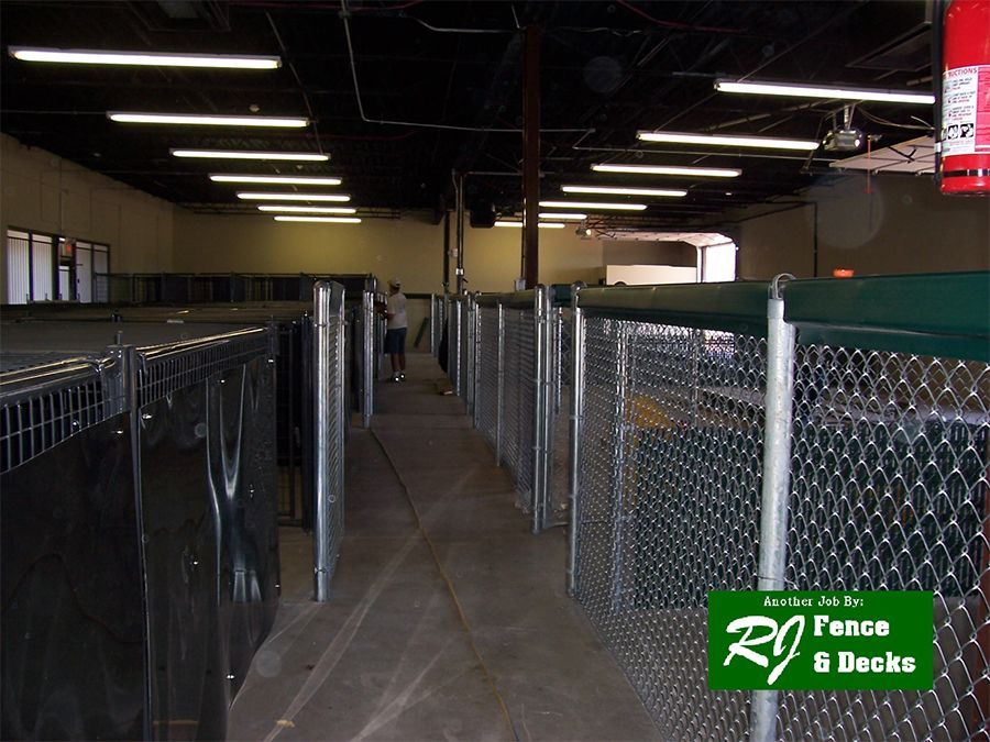 A chain link fence with a sign that says rj fence 8 decks