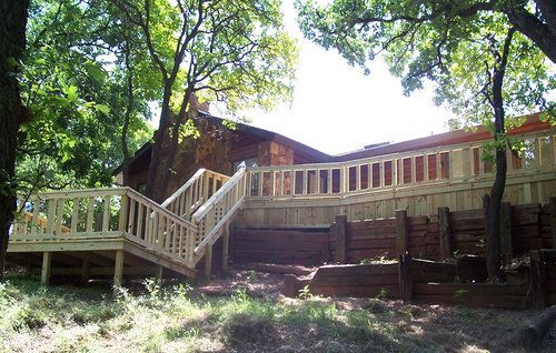 A wooden deck with stairs leading up to it