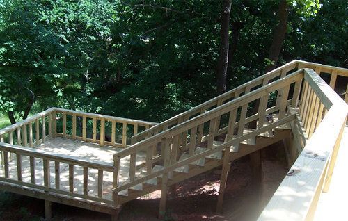 A wooden deck with stairs leading up to it