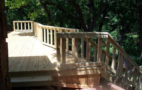 A wooden deck with stairs leading up to it