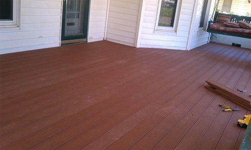 A wooden deck is being built on the side of a house.