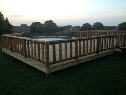 A wooden deck with a pool in the middle of it
