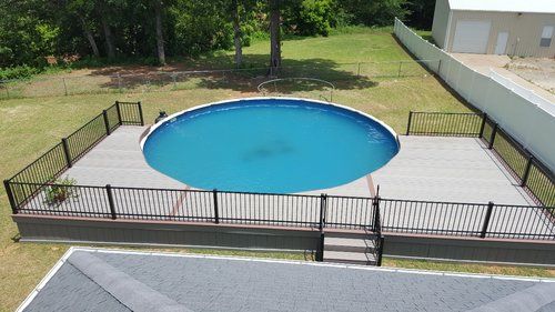 An aerial view of a swimming pool with a fence around it