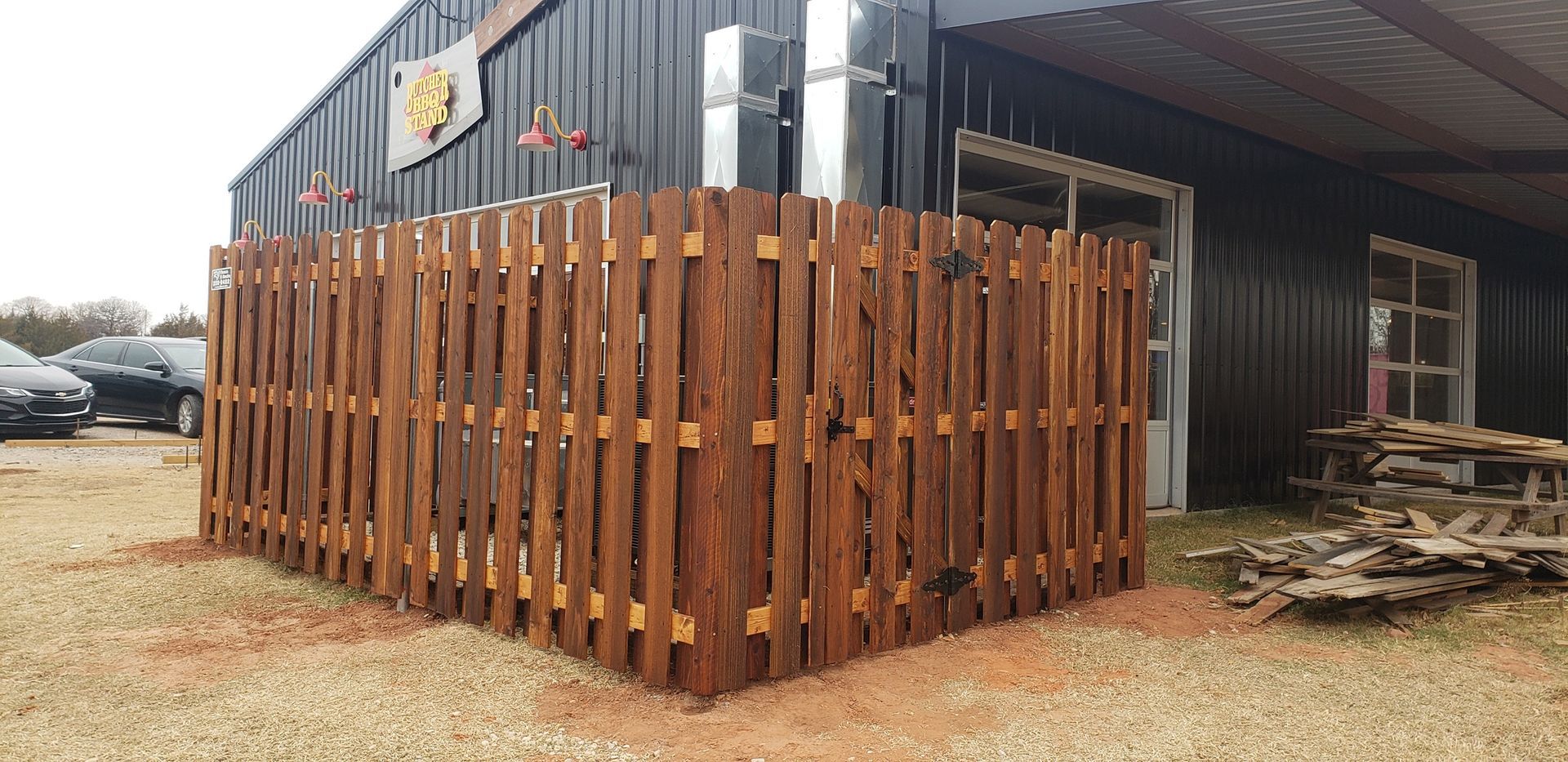 A wooden fence is sitting in front of a building.