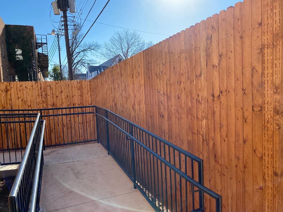 A wooden fence with a ramp leading to it.