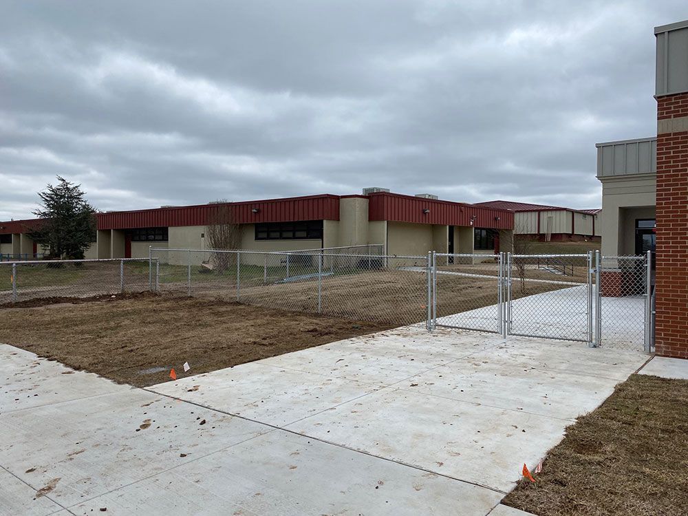 There is a chain link fence in front of a building