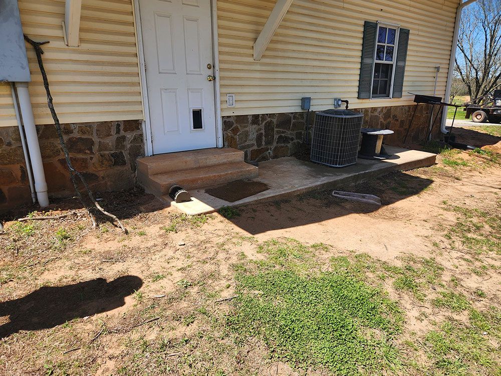 The front of a house with a door and steps