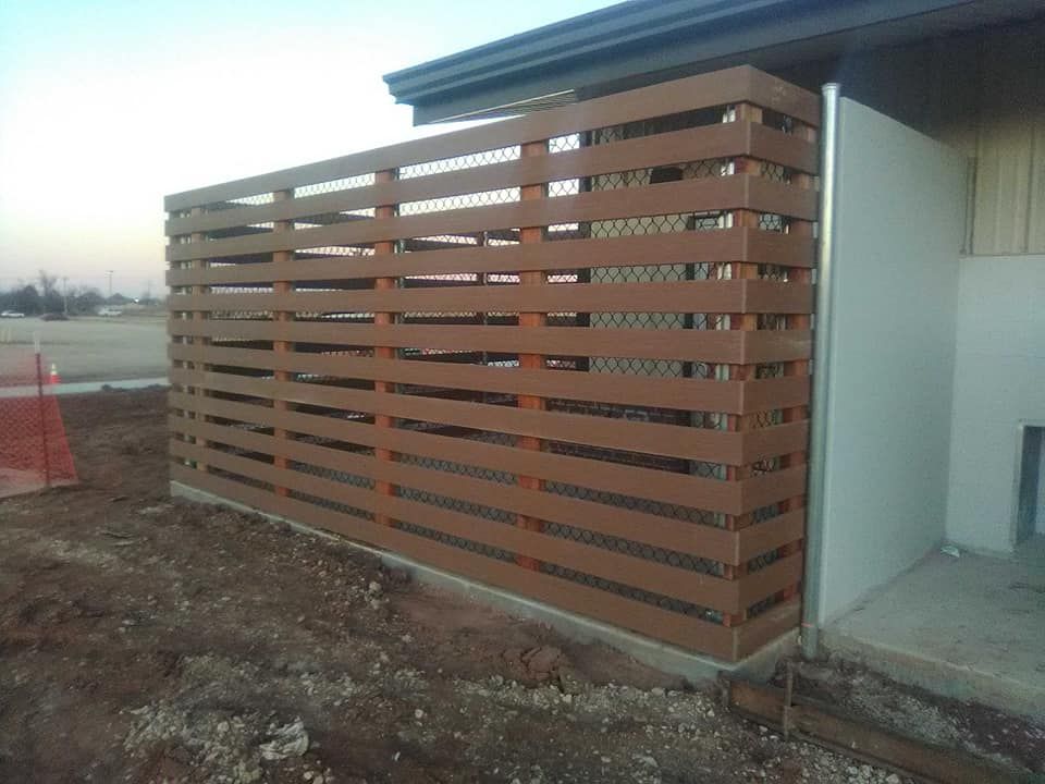 A wooden fence is sitting next to a house