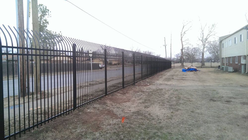 A black metal fence in front of a building