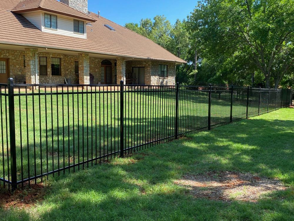 A large house with a black fence in front of it