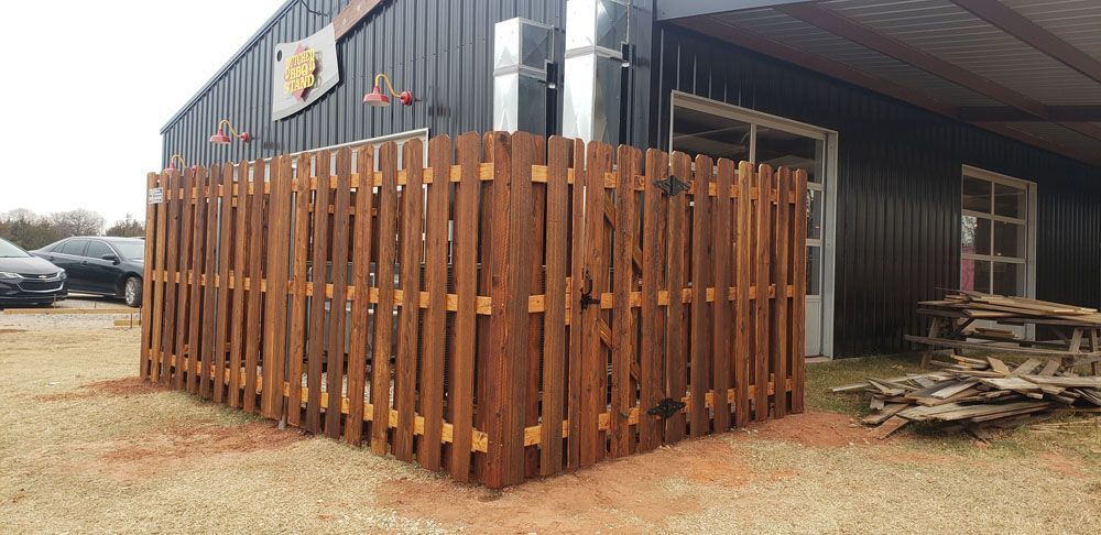 A wooden fence is sitting in front of a building
