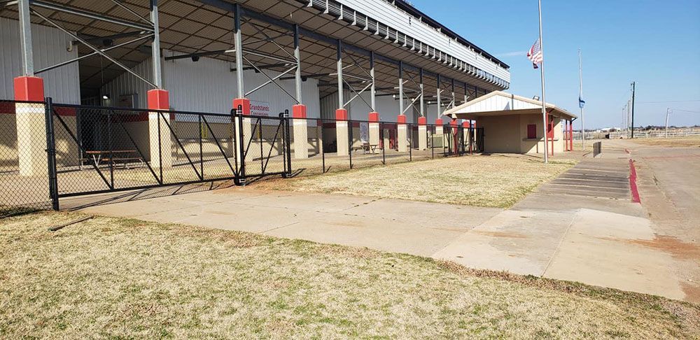 A large white building with a chain link fence around it