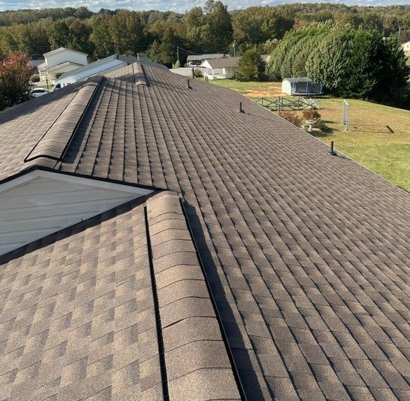 an aerial view of a house with a black roof .